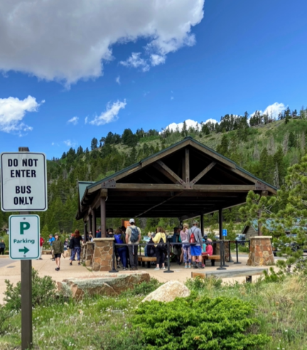 Summers are busy at Rocky Mountain. Image shows a line at the Bear Lake Park and Ride waiting for a bus.