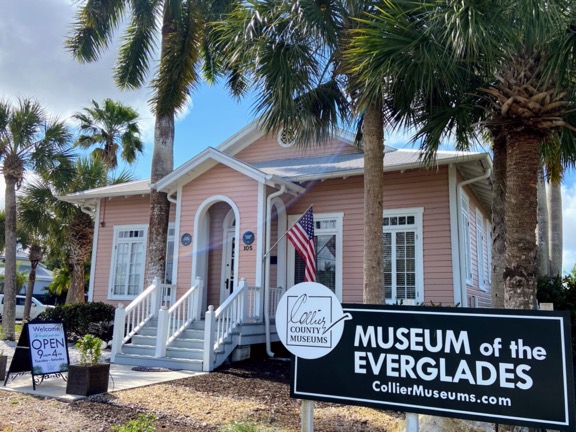 image shows a pink historic house that is now the Museum of the Everglades in Everglades City