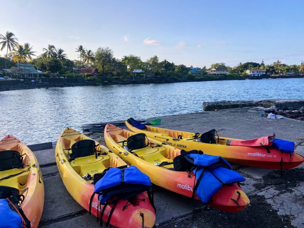 image shows four kayaks lined up outside Kealakekua bay, part of a five day itinerary focused on national parks on the Big Island of Hawaii