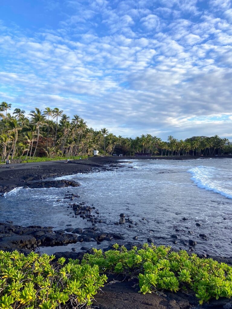 image shows black sand beach at Punaluʻu, part of a five day itinerary focused on national parks on the Big Island of Hawaii
