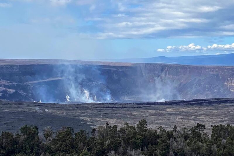 image shows Kilauea Crater with steam from active lava