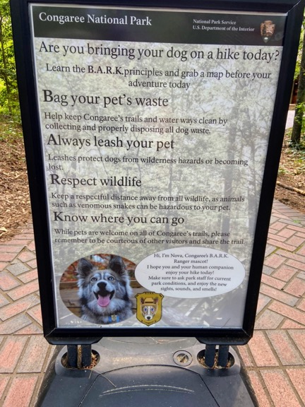 image shows a sign at Congaree National Park with rules to bring your dog