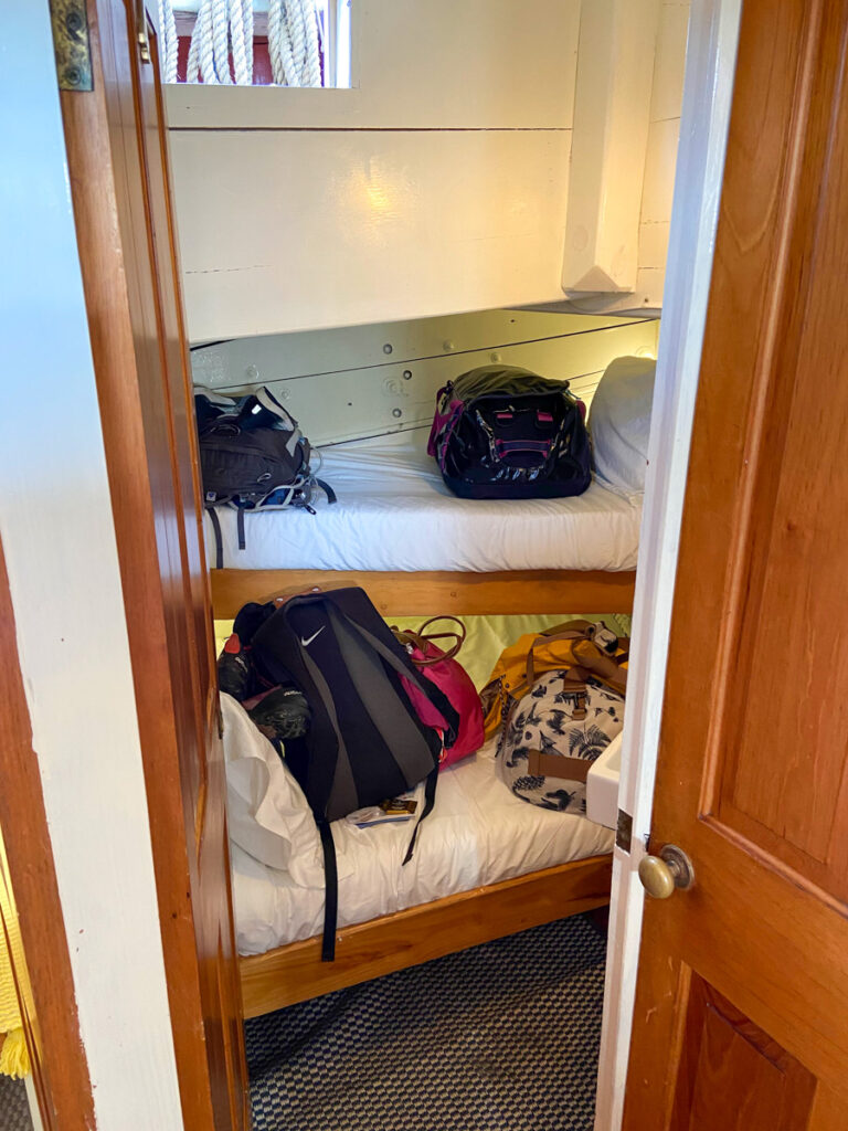 image shows a tiny bunk on a wooden sailboat