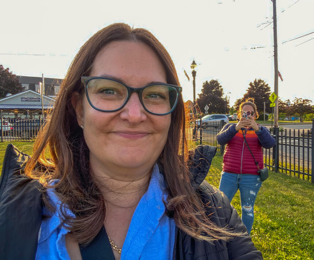 image shows one woman mugging for the camera while her sister takes a photo of her doing that.