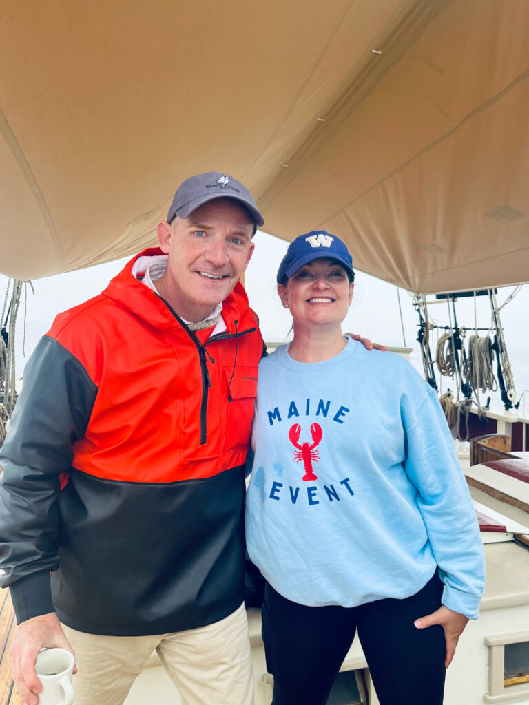 image shows actor Marc Evan Jackson standing with a woman on a schooner