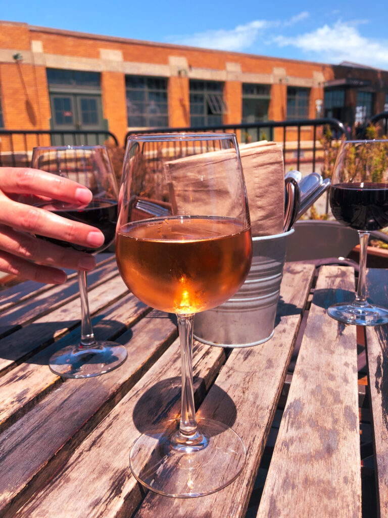 image shows three glasses of wine while patio day drinking in Seattle