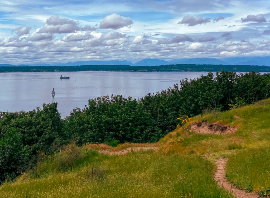 image shows a view from bluff at Discovery Park over Puget Sound in Seattle