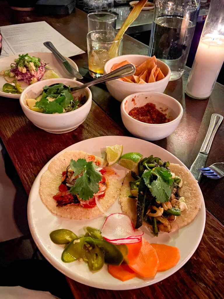 image shows mexican food, including tacos and salsa at a restaurant