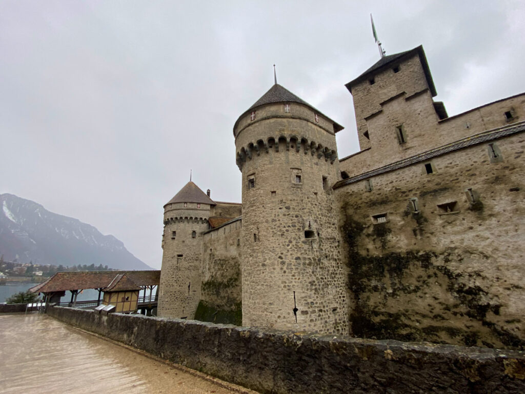 image shows chateau de chillon, a medieval castle in montreux on a rainy winter day