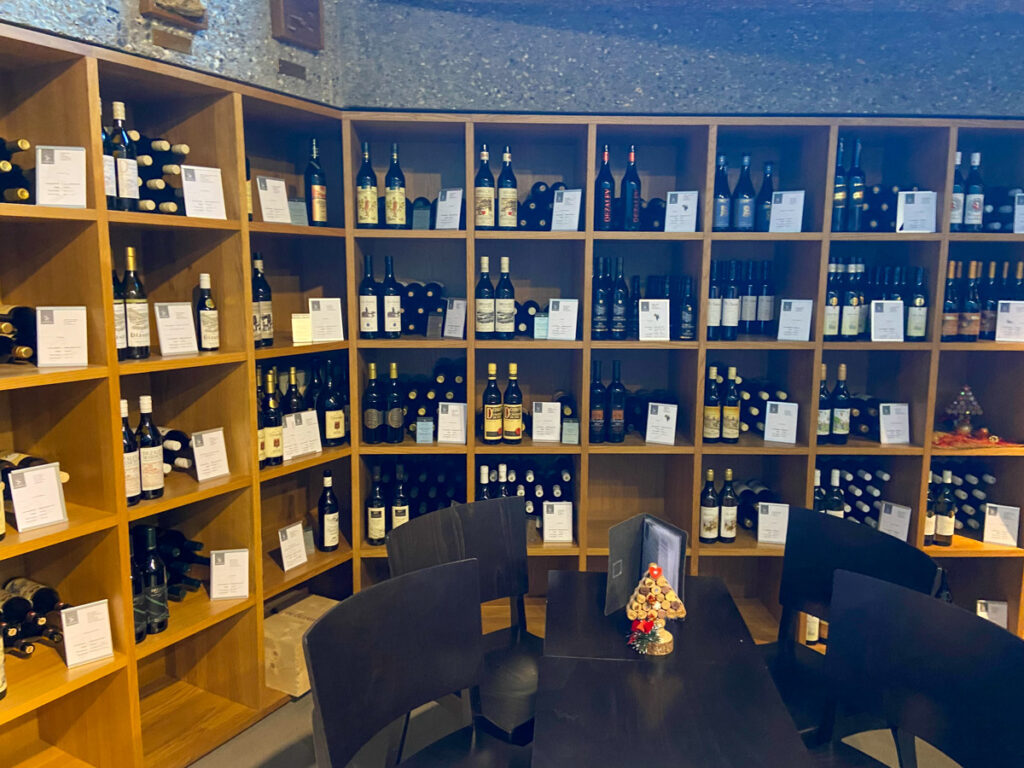 the inside of the Vinorama tasting room in Lavaux region has bookshelves full of wine